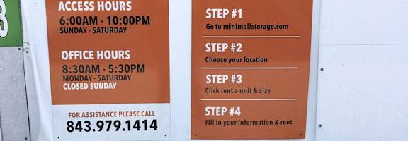 A sign for Mini Mall Climate Control advertises their services and contact information.