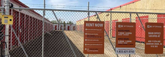 A fenced area with a sign that says "Rent Now" and "Eni Storage".