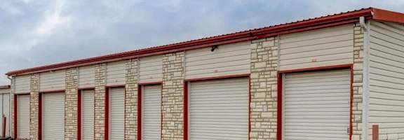 A long storage unit building with red and white trim.