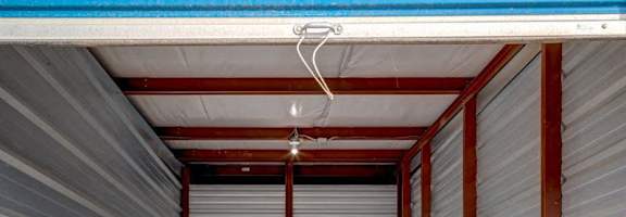 A storage unit with a blue ceiling and grey walls.