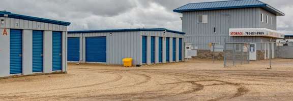 A storage facility with a sign that reads "STORAGE" and a phone number.