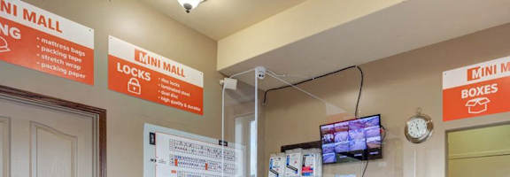 A reception area with a wooden desk and a sign that says "Mini Mall".