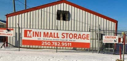 A storage facility called Mini Mall Storage is shown with a red and white sign.