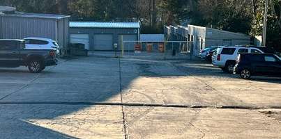 a parking lot filled with cars and a building