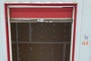 an open garage door with snow on the floor