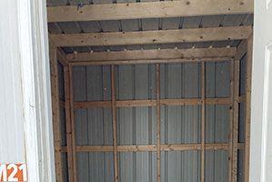 an empty room with shelving in a room with a door