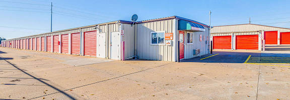 A storage facility with red and white doors.