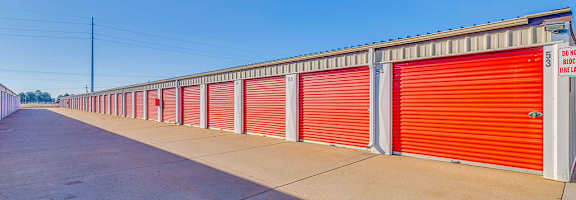 A long row of red storage units with the words "DUCKS FIELD" on the side.