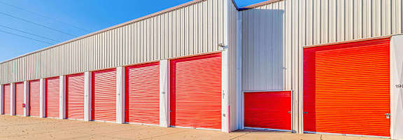 A long row of red and white storage units with closed doors.