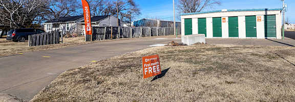 A sign in front of a building says "For Rent".