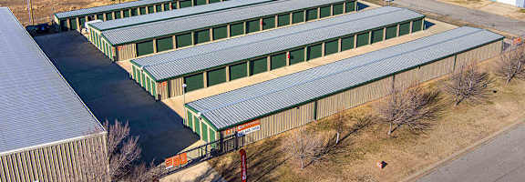 A large industrial area with green and grey buildings.