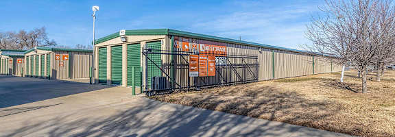 A storage facility with a green and orange sign.
