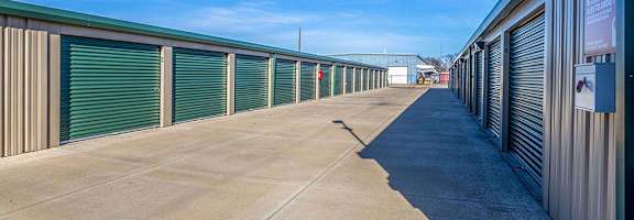 A long row of storage units with closed grey doors.