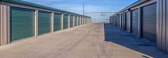 A long row of storage units with closed grey doors.