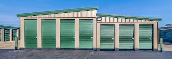 A storage facility with green doors and a green roof.