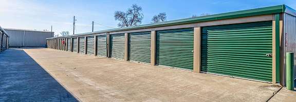 A row of green storage units with closed doors.