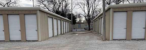 A long row of storage units with the first one numbered 5.