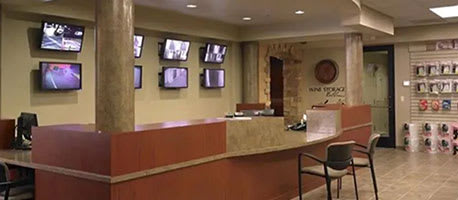 A reception area with a desk and multiple TVs on the wall.