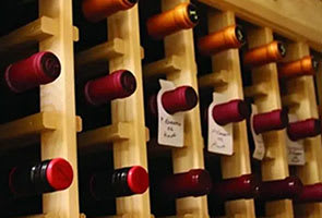 A wine rack with several bottles of wine.