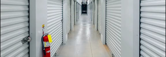 an empty warehouse with doors and a fire hydrant
