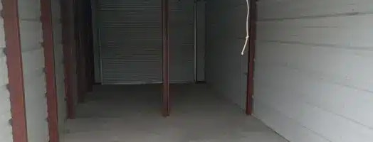 the inside of a garage with a white floor