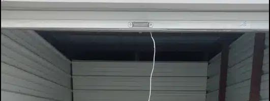 the inside of a garage with a white floor and a door