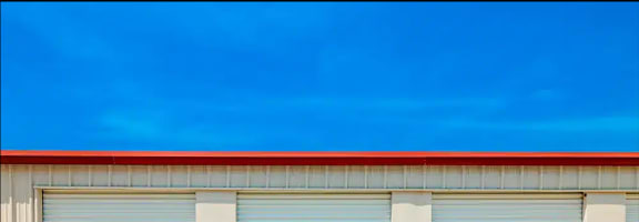 the side of a building with three garage doors
