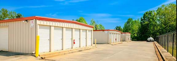 a row of garages and sheds in a parking lot