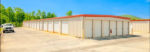 a large warehouse building with a car parked in front of it