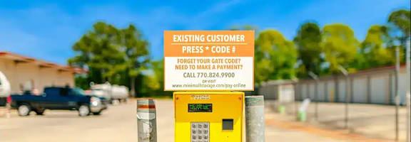 a parking meter in a parking lot with a yellow sign