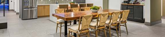 A modern dining room with a wooden table and chairs.