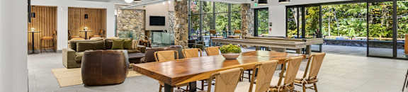 A modern dining room with a large table and chairs.