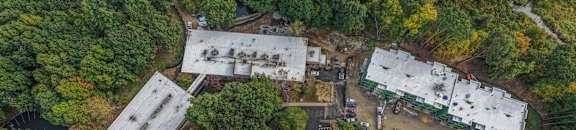 An aerial view of a large building surrounded by trees.