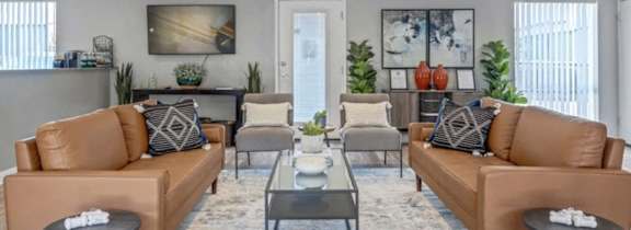 a living room with couches and chairs and a table