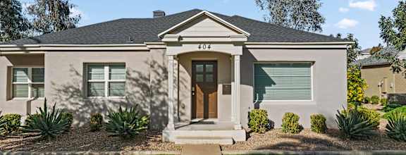 A house with a brown front door and a small porch.