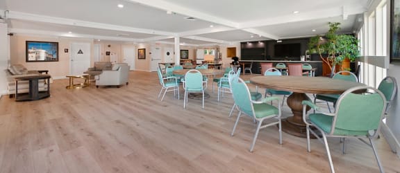 a resident clubhouse with tables and chairs at The Crest at Citrus Heights Apartments, Citrus Heights, 95621