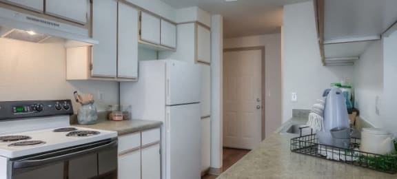 Kitchen with plank flooring and white cabinetry at Parkside Apartments, Gresham, OR