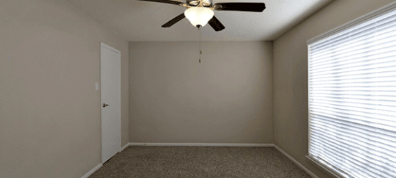 Model home empty bedroom with ceiling fan