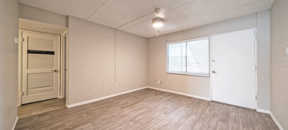 Living room with wood flooring and a white door