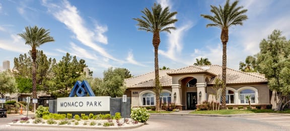 a clubhouse with palm trees and a sign that says monaco park