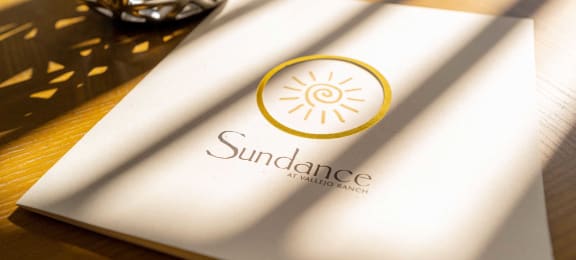 a napkin with a sun dance logo on a table