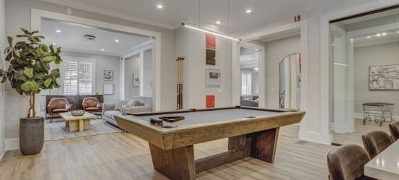 a pool table is in the center of a living room
