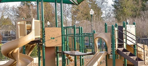 a playground with two slides and two chairs