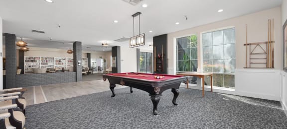 a rec room with a pool table and a bar
