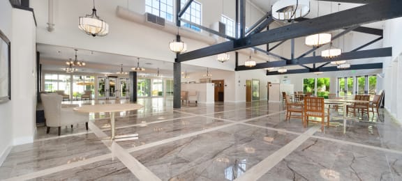 a large open room with a marble floor and exposed beams