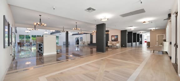 a large lobby with hardwood floors and white walls