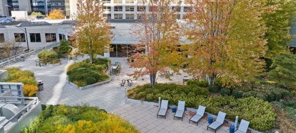 a park with benches and trees in front of a building at Presidential Towers, Chicago, 60661