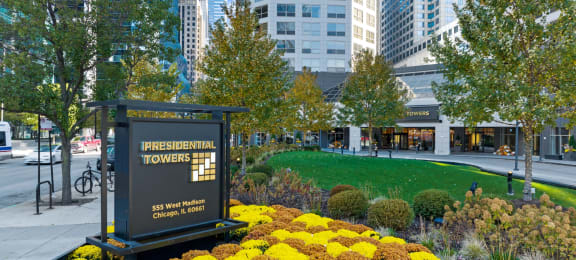 a commemorative sign in front of a park with flowers at Presidential Towers, Illinois, 60661