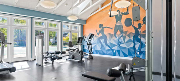 Fitness center flooded with natural light at Rosemont Square Apartments, Randolph, Massachusetts