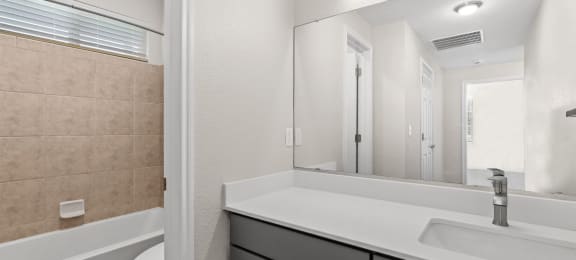 bathroom with sink and mirror at Switchback on Platte Apartments, Colorado, 80120